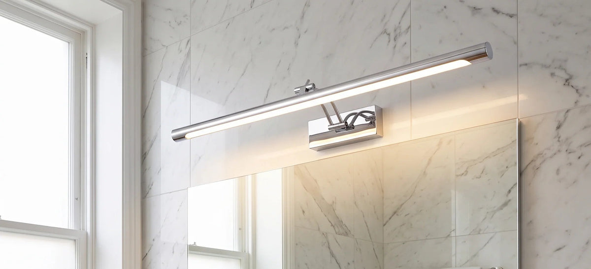 Kensal chrome vanity light above a wide bathroom mirror