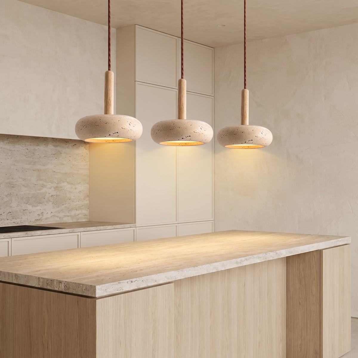Three Siena travertine pendants over a kitchen island