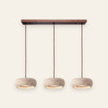 Aldridge travertine 3 light island pendant with walnut bar, cream background