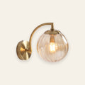 Ashcombe ribbed glass globe wall light in amber, cream background
