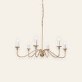 Ashworth gold six light candle chandelier on a cream background