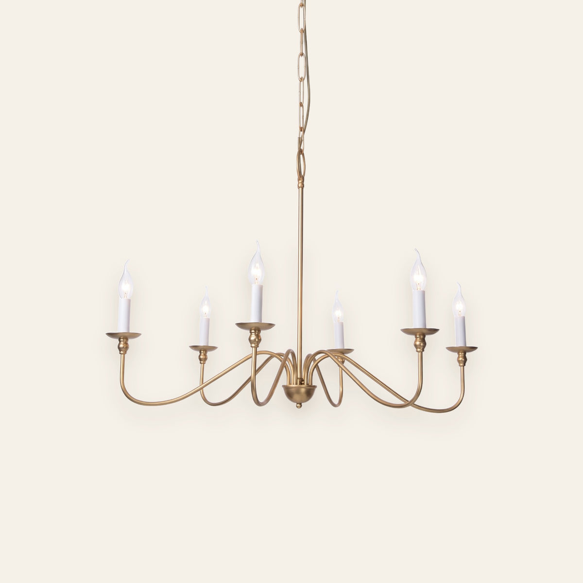 Ashworth gold six light candle chandelier on a cream background