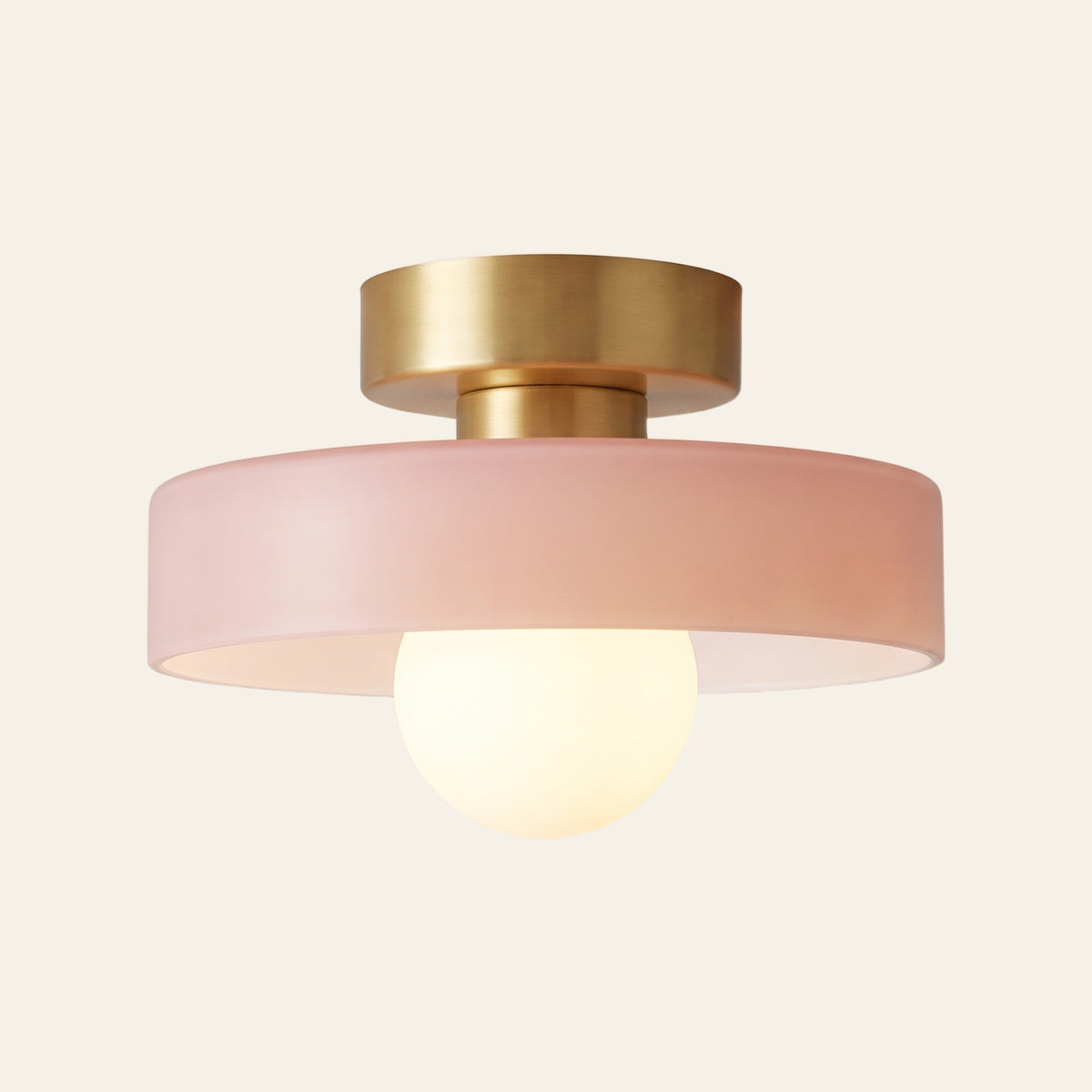 Bawdsey flush ceiling light with a blush pink glass disc, cream background