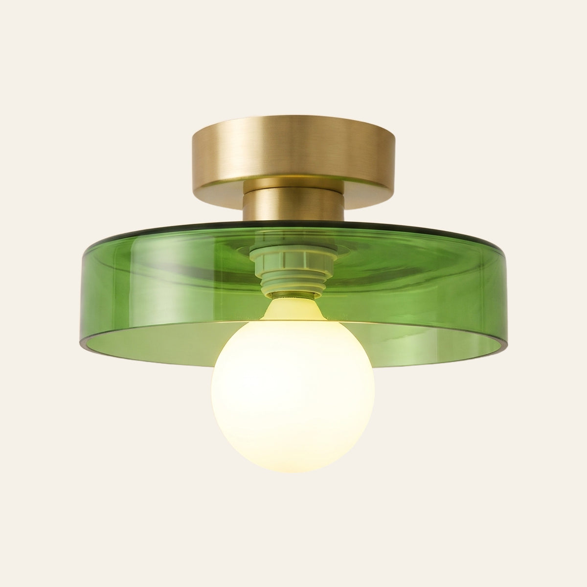 Bawdsey flush ceiling light with a green glass disc, cream background