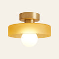 Bawdsey mid century flush ceiling light, honey glass disc on a brass canopy with a globe bulb, cream background