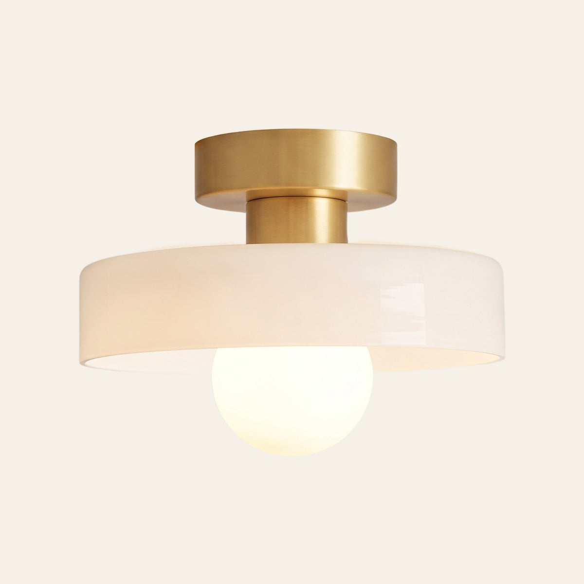 Bawdsey flush ceiling light with an opal glass disc, cream background