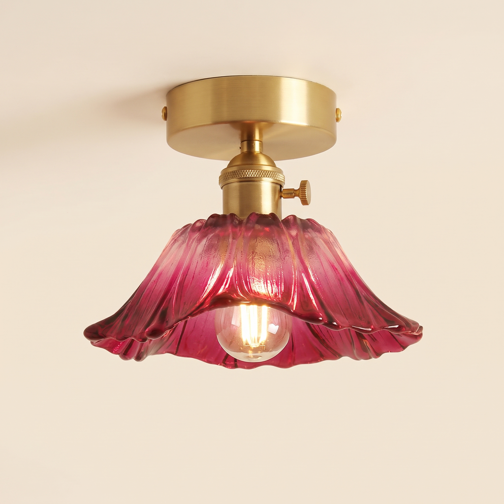 Benhall 19 cm semi flush ceiling light with a raspberry pink fluted glass shade on a brass fitting, cream background