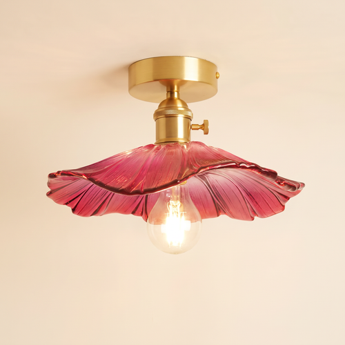Benhall 28 cm semi flush ceiling light with a raspberry pink sunflower glass shade on a brass fitting, cream background