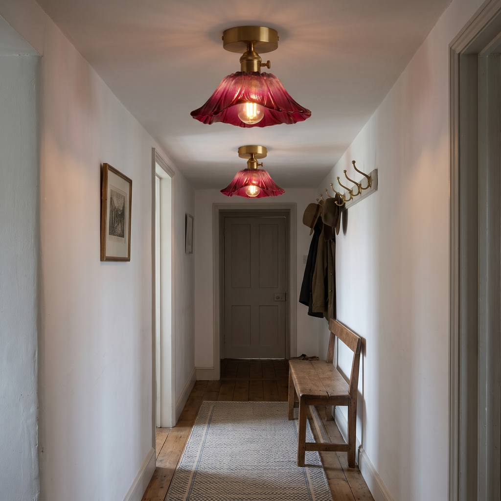 Two small raspberry Benhall ceiling lights lit along a white cottage hallway