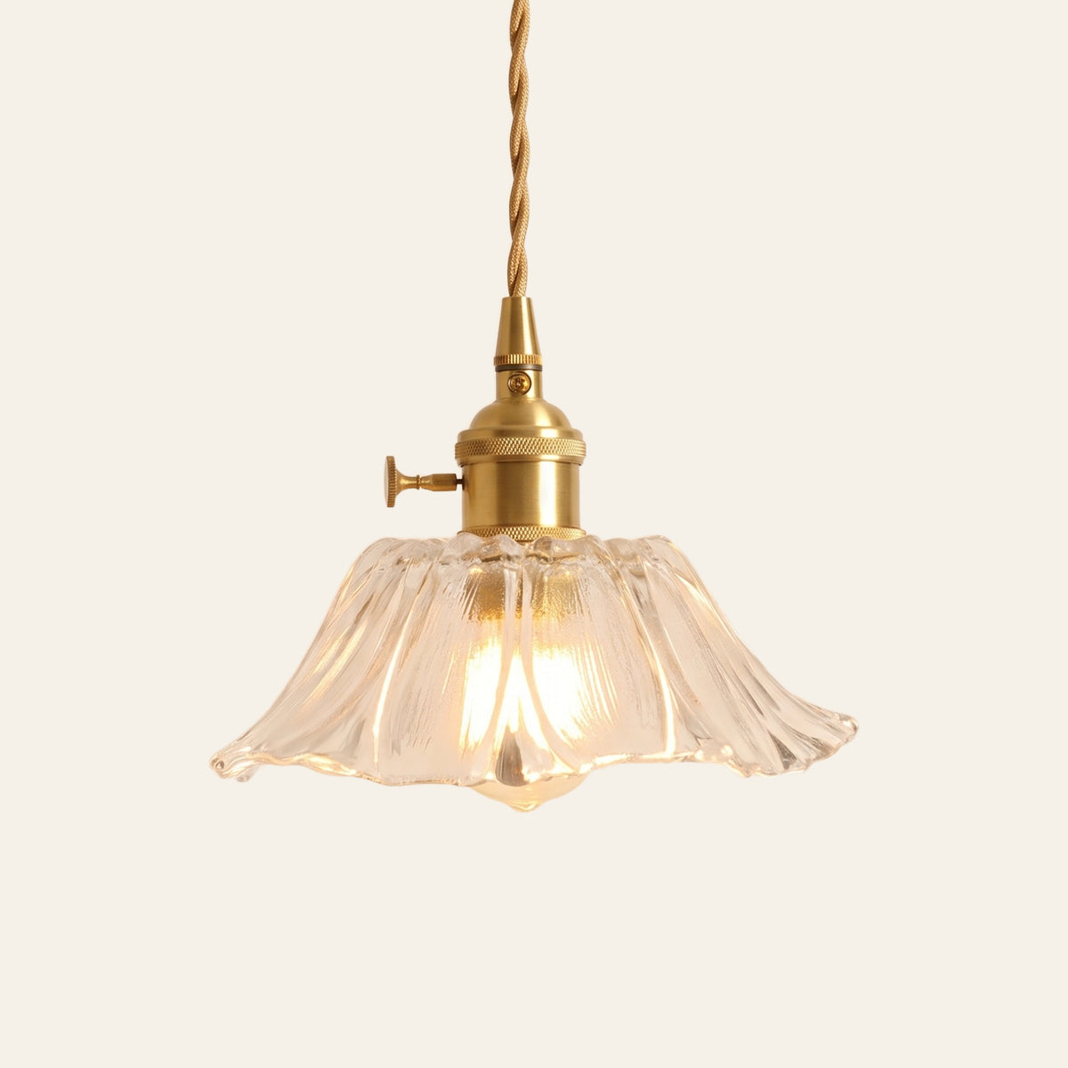 Benhall 19 cm sunflower glass pendant light in clear fluted glass on a brass holder, cream background