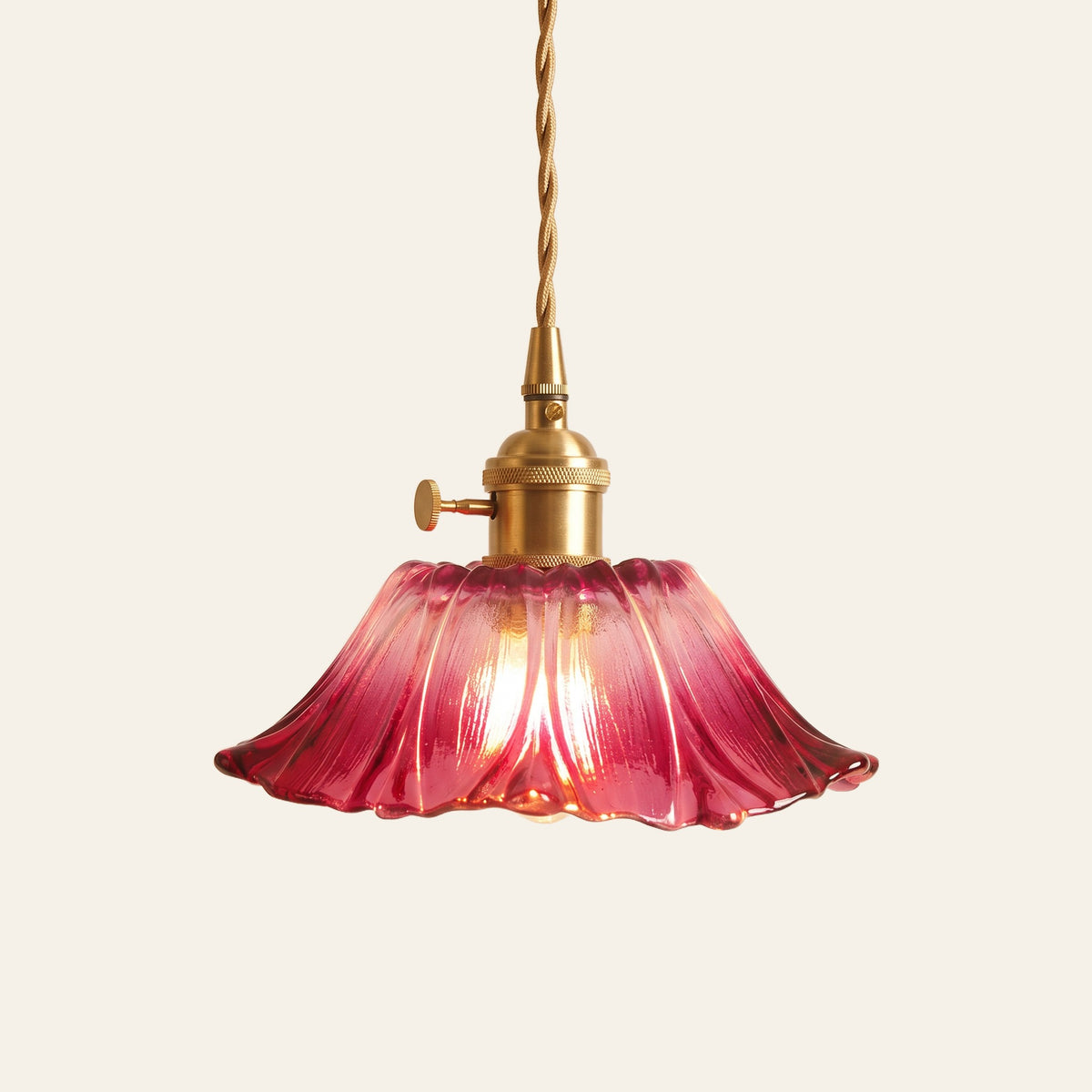 Benhall 19 cm sunflower glass pendant light in raspberry pink glass on a brass holder, cream background