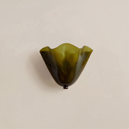 Blythburgh wall light, a folded handkerchief shade of olive green glass with a waved rim, on a cream wall