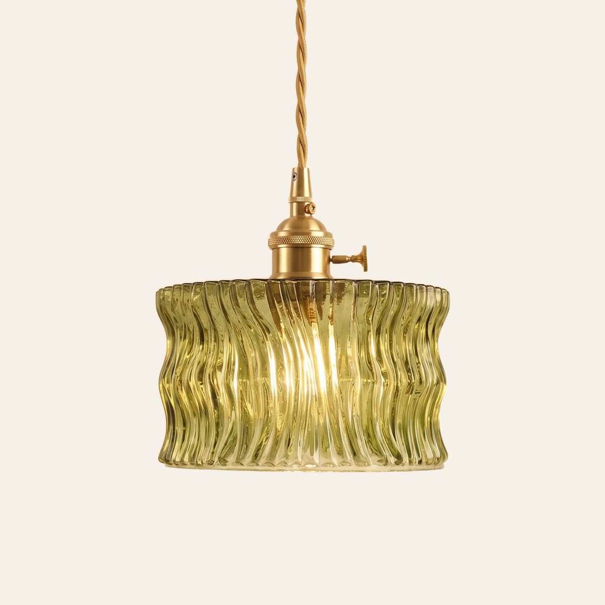 Boxford wavy ribbed glass cylinder pendant light in olive green glass on a brass holder with a twisted cord, cream background