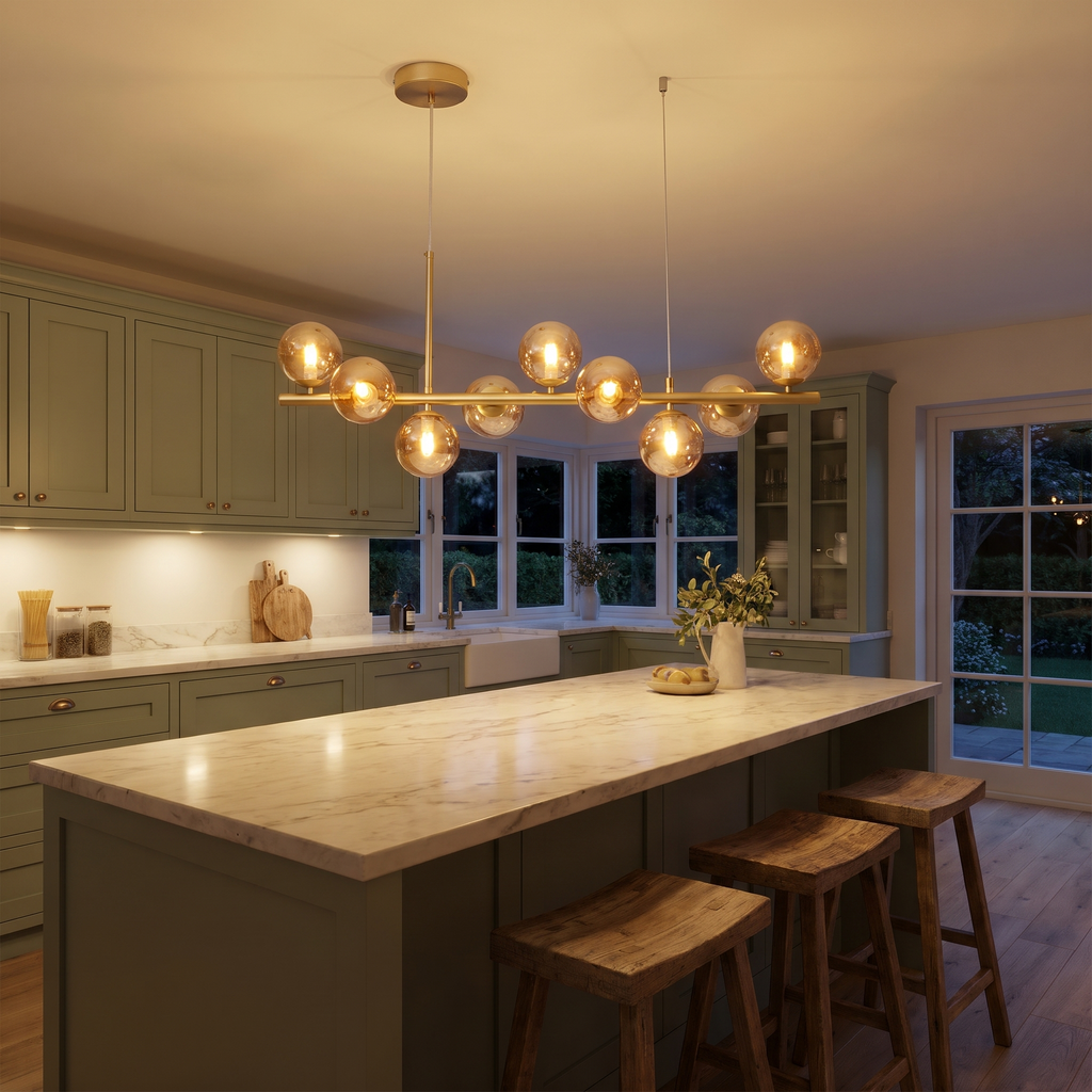 Brandeston 9 light amber glass globe chandelier lit over a marble kitchen island
