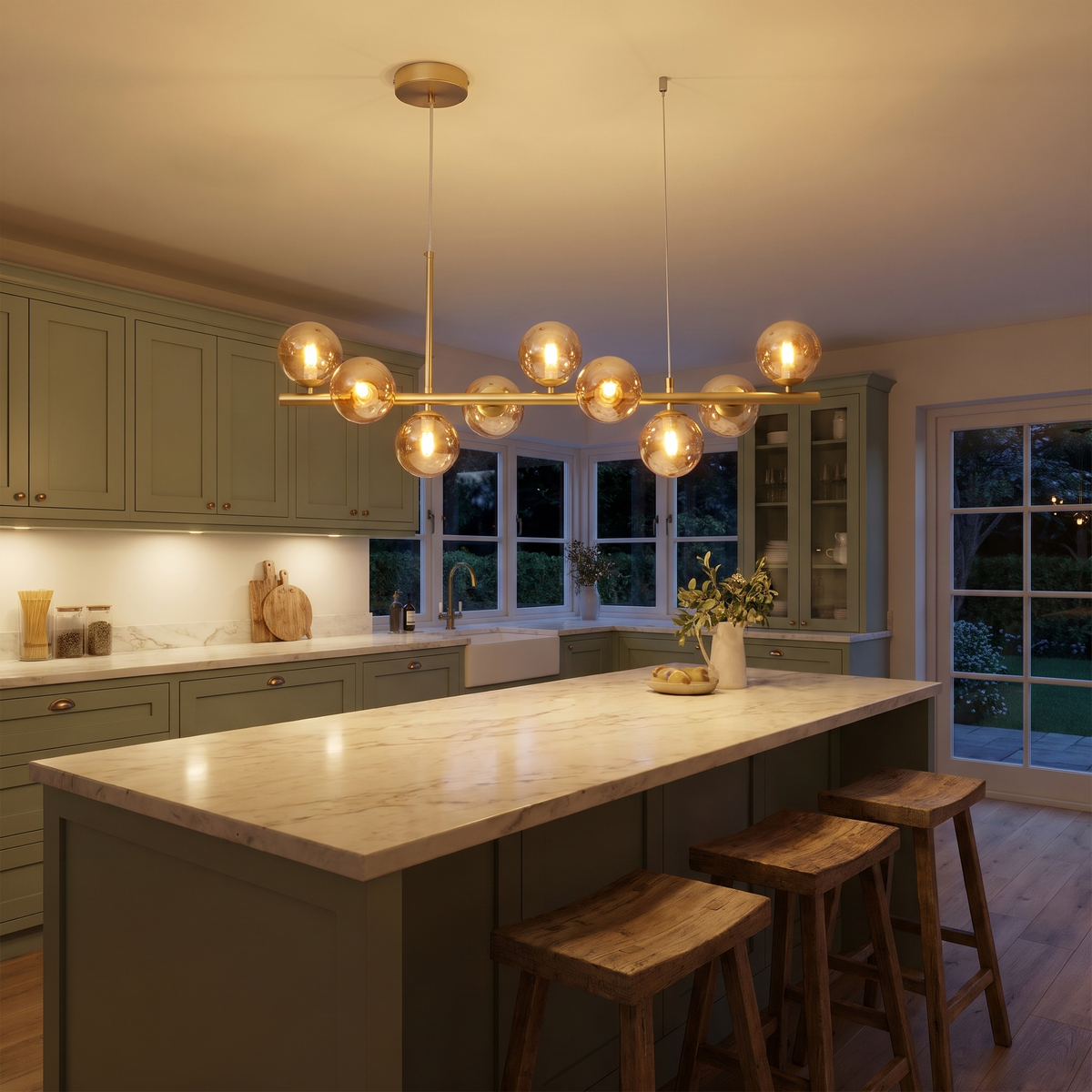 Brandeston 9 light amber glass globe chandelier lit over a marble kitchen island