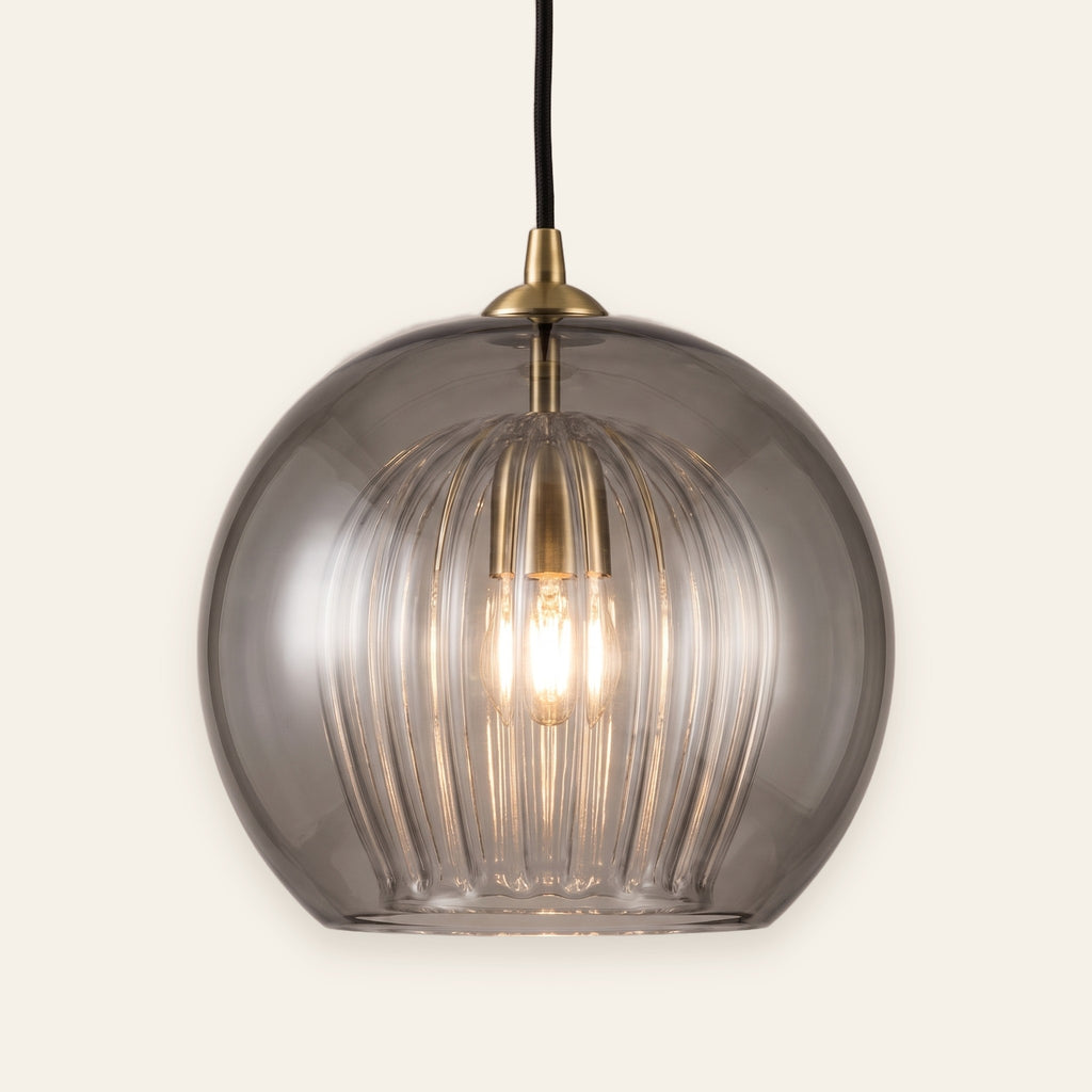 Corran smoked glass double globe pendant with brass cap, cream background