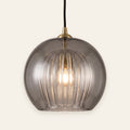 Corran smoked glass double globe pendant with brass cap, cream background