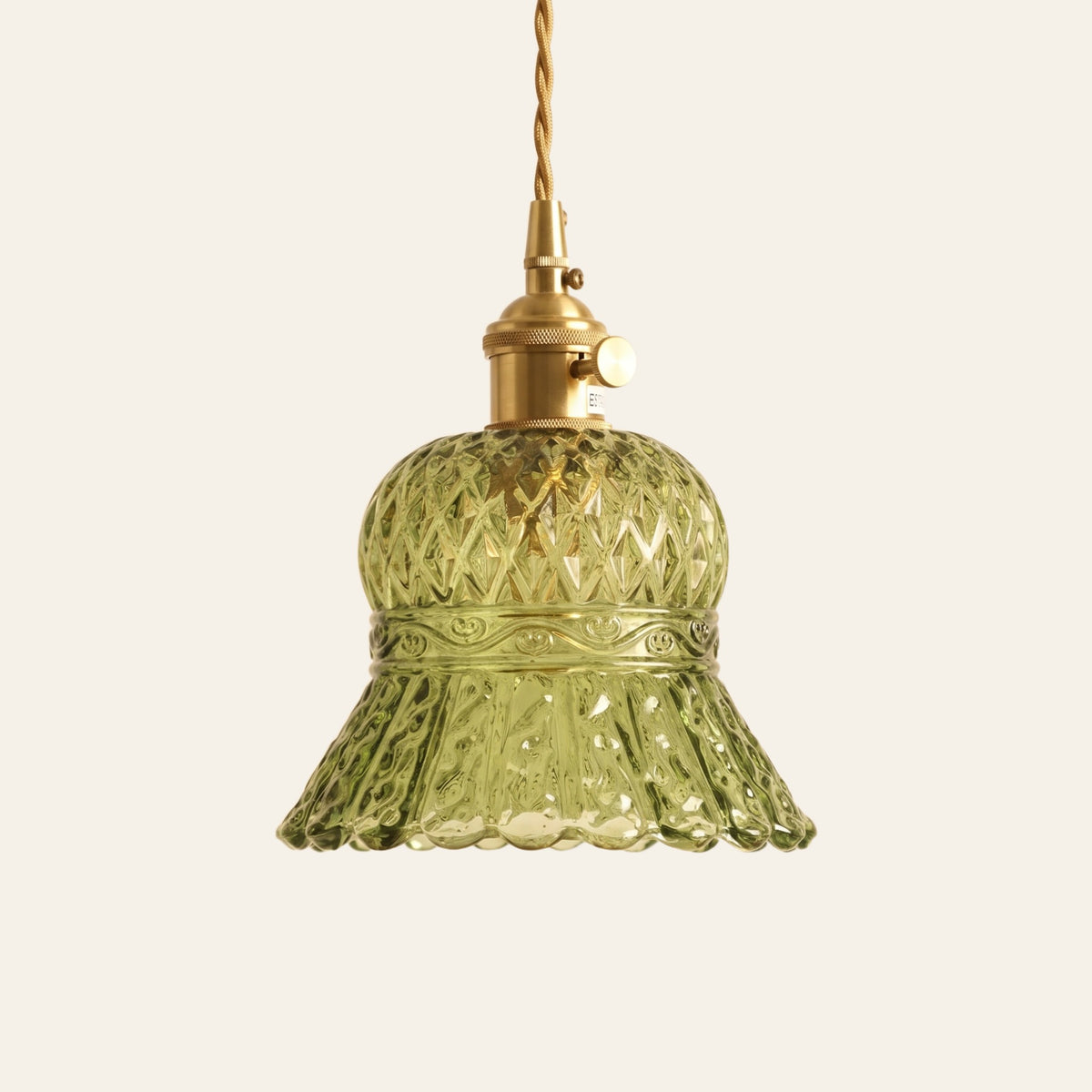 Cratfield pressed glass bell pendant light in green with a diamond pattern and brass switch holder, cream background