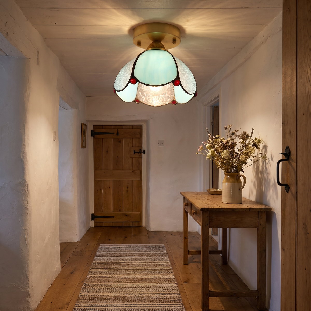 A lit Darsham stained glass tulip ceiling light on a low hallway ceiling