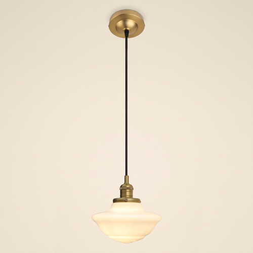 Ely pendant light with a stepped opal milk glass schoolhouse shade on a black cord, antique brass lamp holder and ceiling plate, cream background