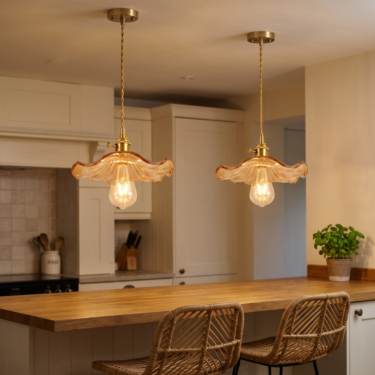 Two amber Framlingham lotus leaf pendants lit over a breakfast bar