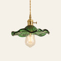 Framlingham lotus leaf glass pendant light in green glass with the bulb below, brass holder, cream background