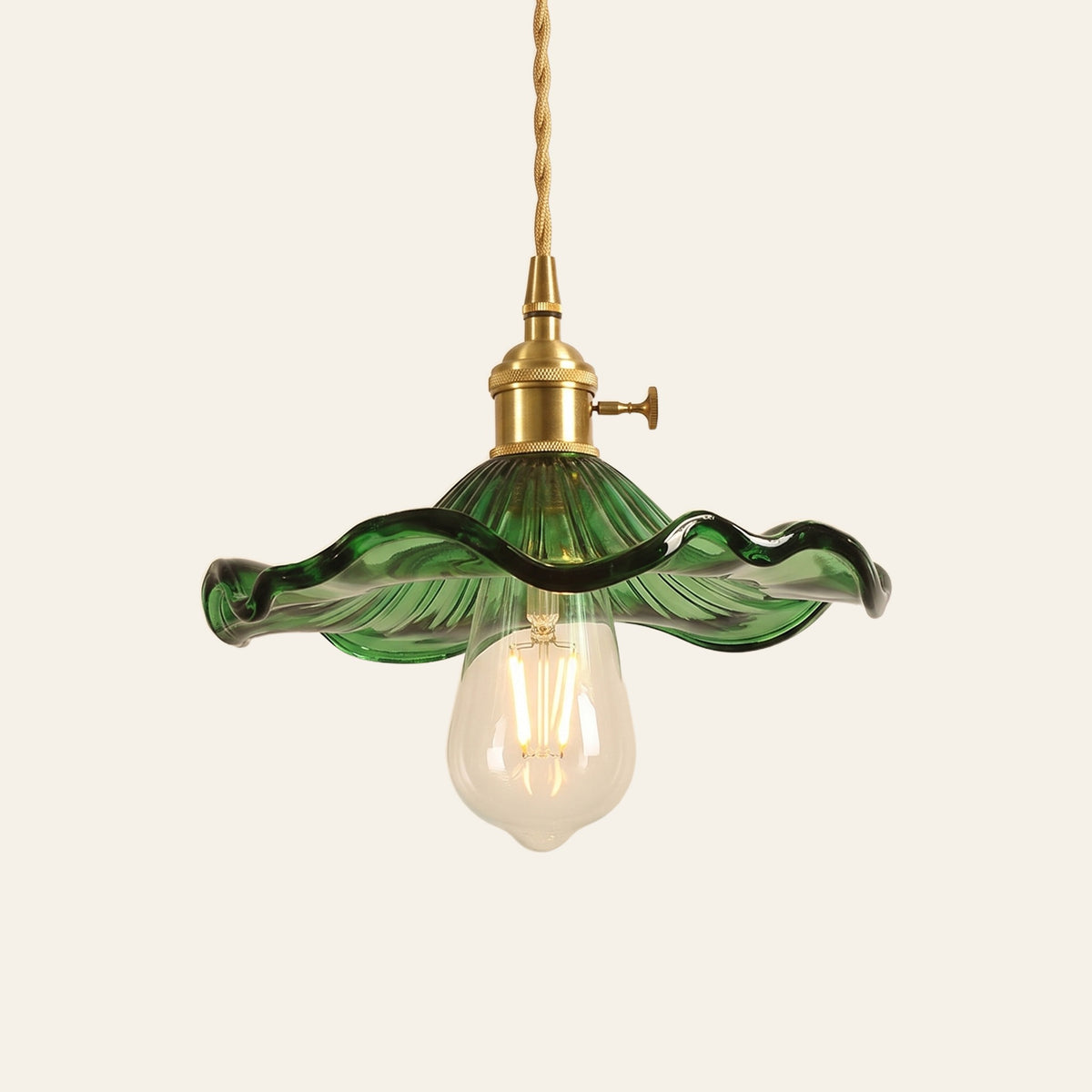 Framlingham lotus leaf glass pendant light in green glass with the bulb below, brass holder, cream background
