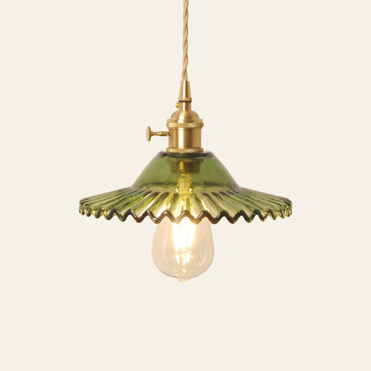 Glemsford fluted glass coolie pendant light in olive green glass on a brass holder with a twisted cord, cream background