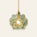 Halesworth pendant light with a round shade of sea green textured glass petals edged in brass, lit