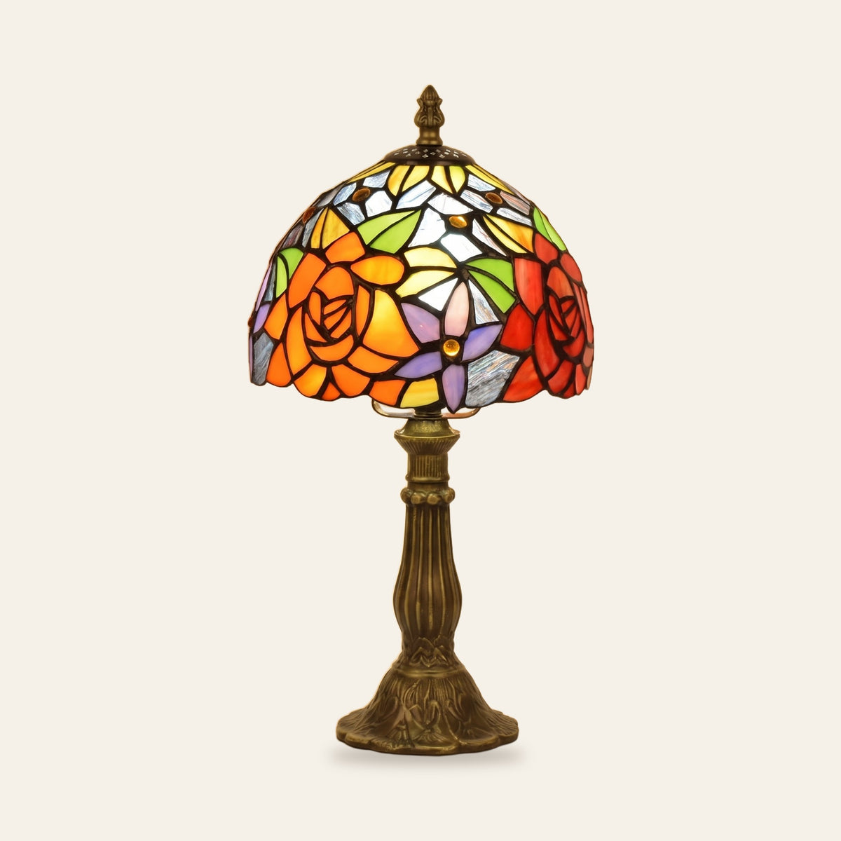 Hartest stained glass table lamp with a leaded shade of orange and red roses on a bronze finish base, cream background