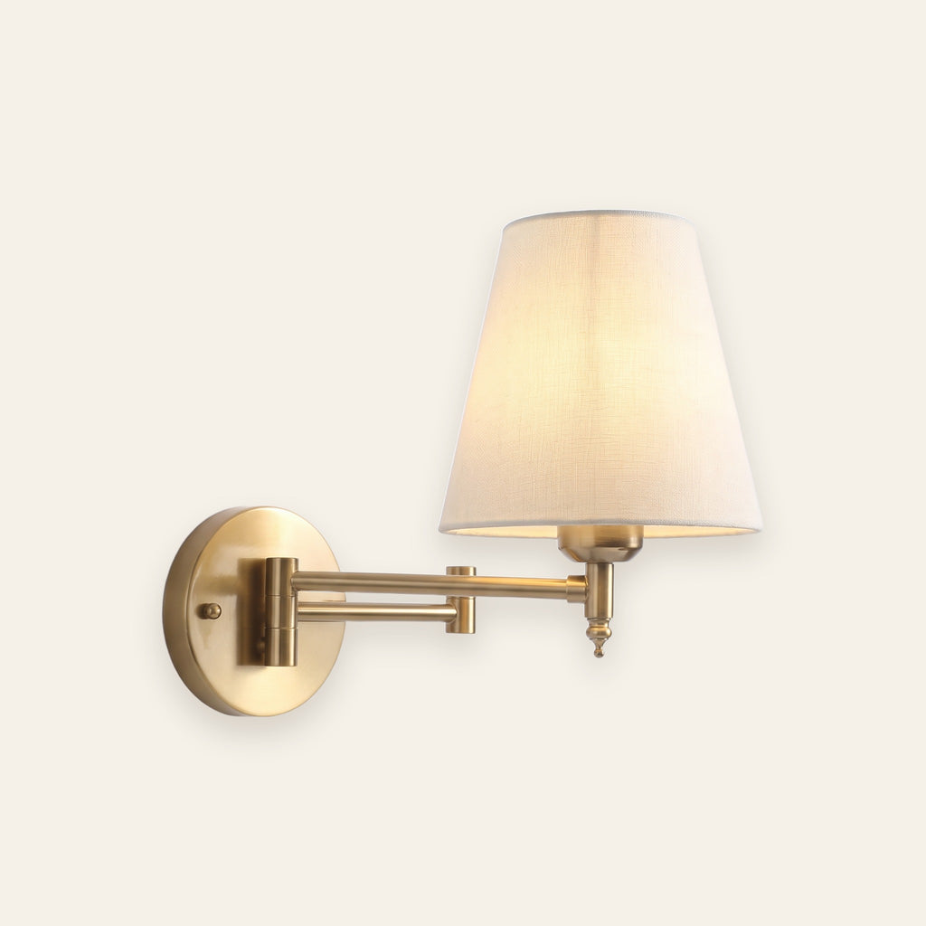Hatton swing arm wall light in brass with a linen look shade, cream background