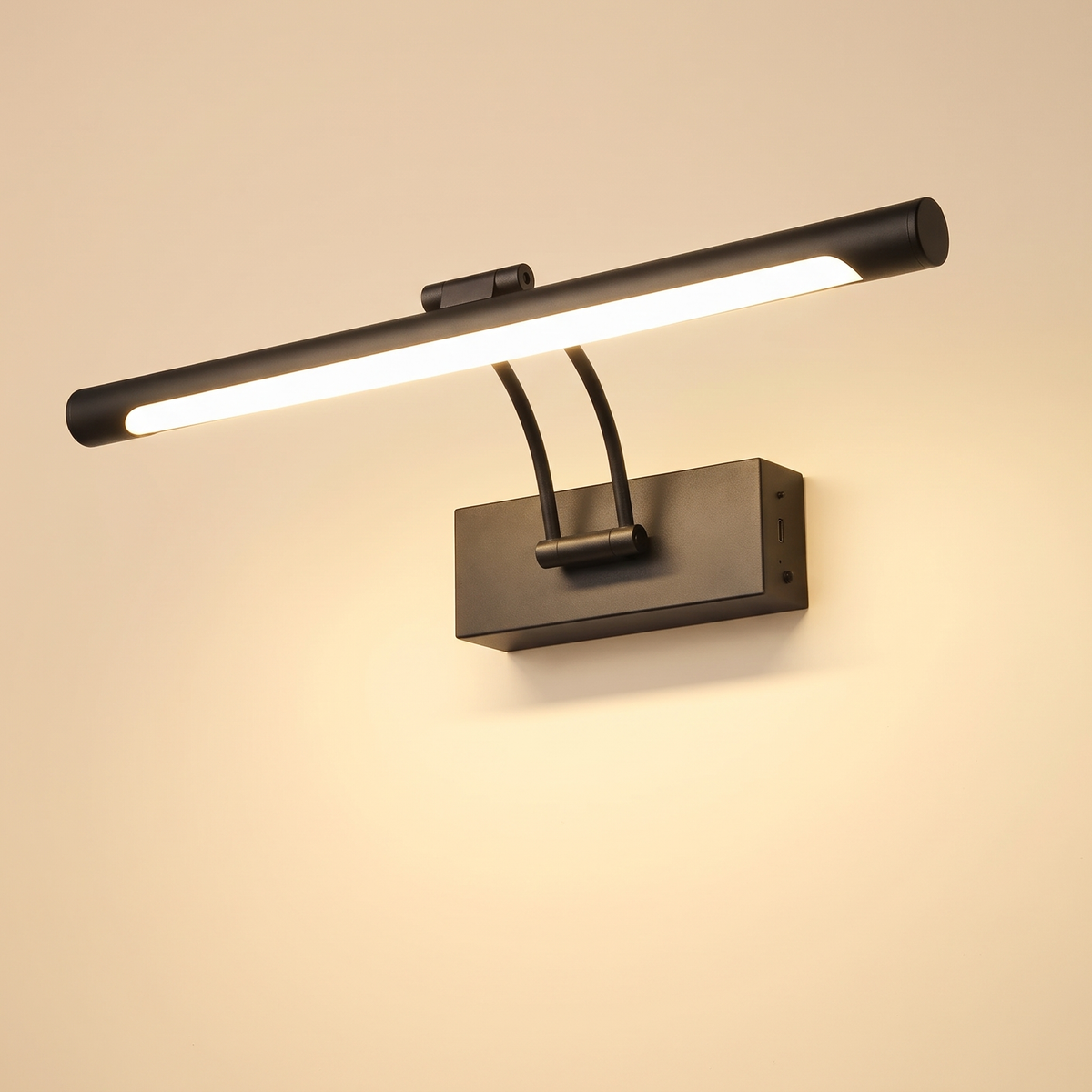 Helmingham rechargeable picture light in matte black, a 40 cm tube bar on two curved arms from a rectangular wall box, lit, cream background