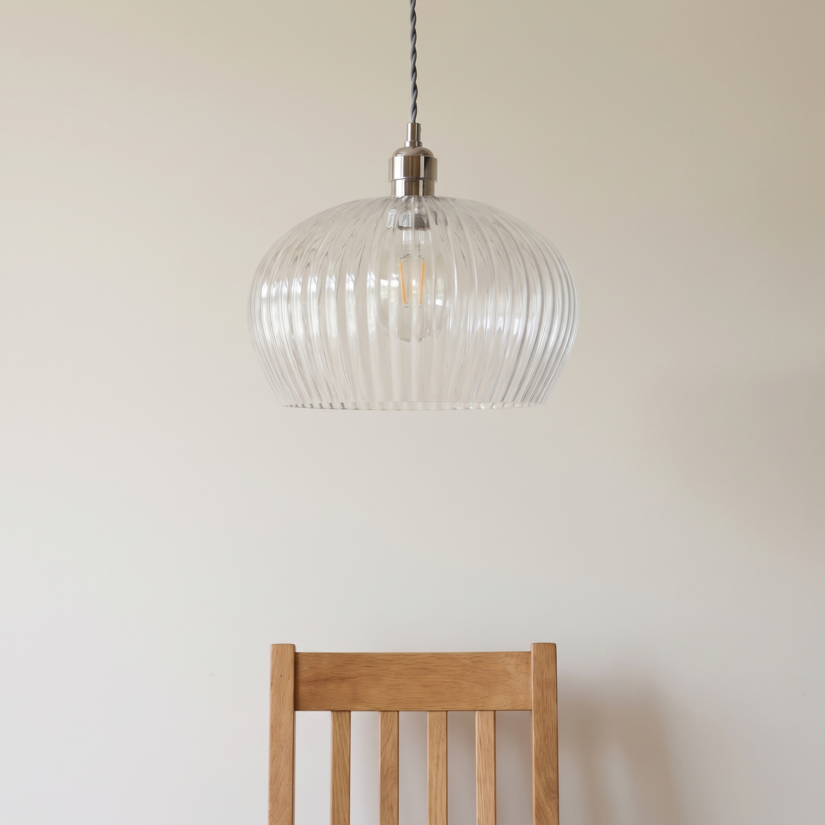Sereno pendant light shown above a dining chair for size reference