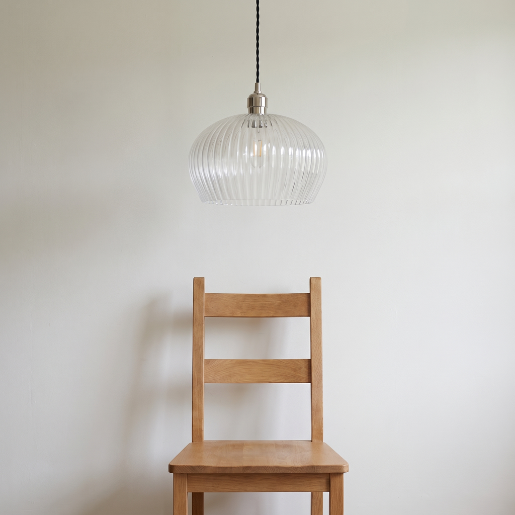 Lumira pendant light shown above a dining chair for size reference