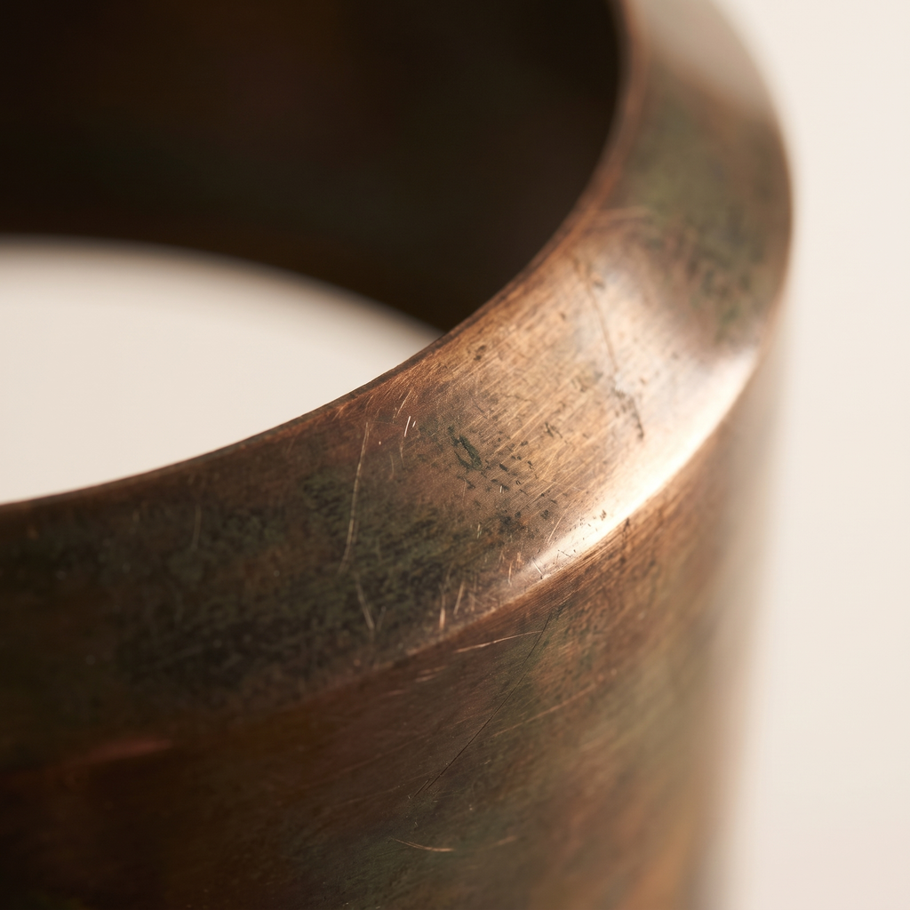 Close detail of the aged bronze patina finish on the Veniro pendant