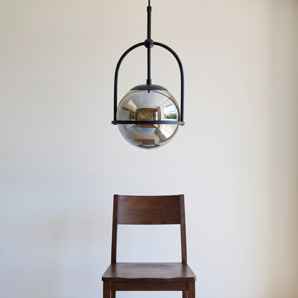 Noctis pendant light shown above a dining chair for size reference