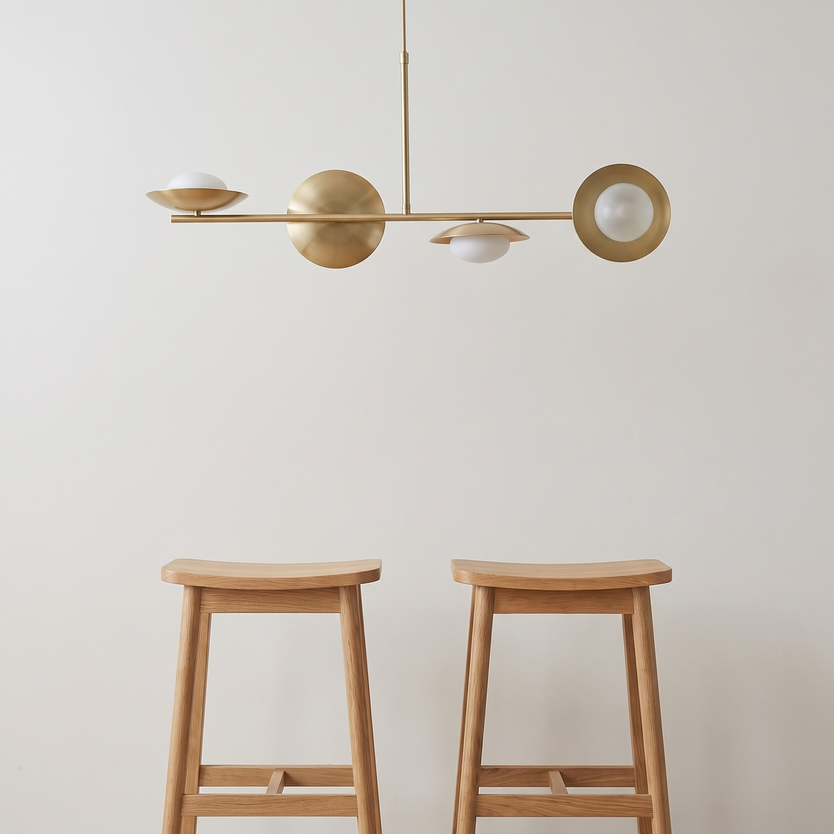 Linvara linear bar pendant shown above two bar stools for size reference
