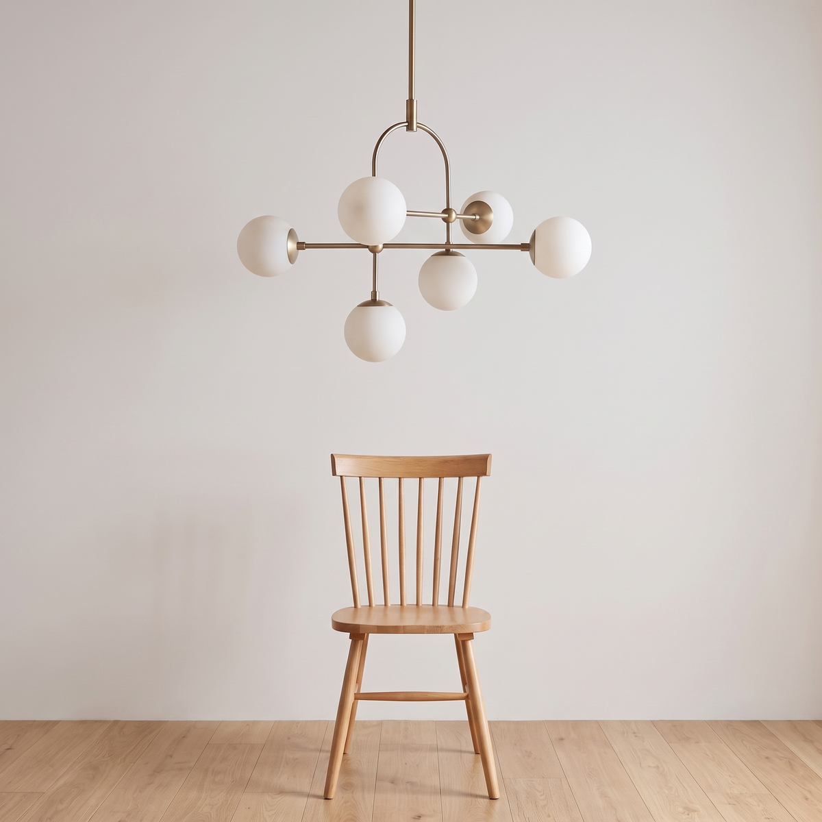 Aurelle chandelier shown above a dining chair for size reference