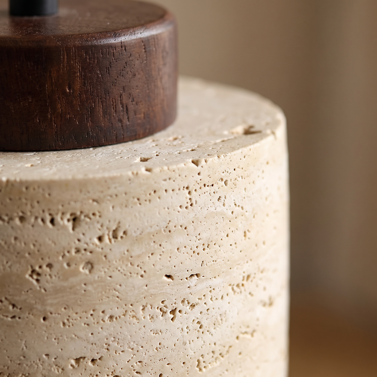 Close up of the travertine stone texture and walnut wood crown
