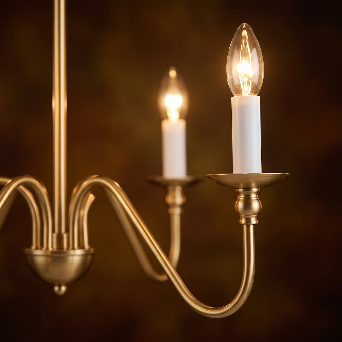 Close up of a gold candle arm on the Ashworth chandelier