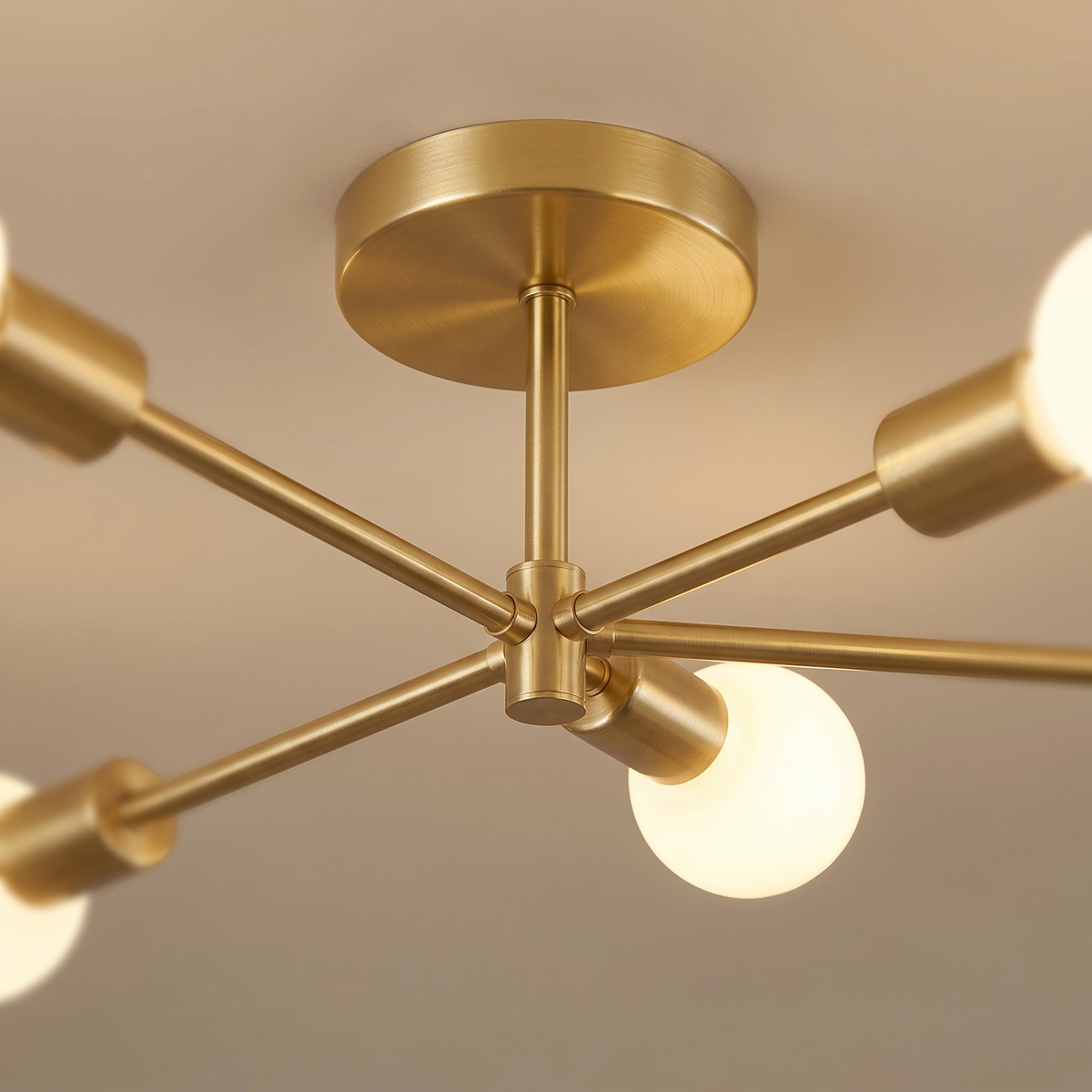 Close up of the gold ceiling plate and sputnik arms
