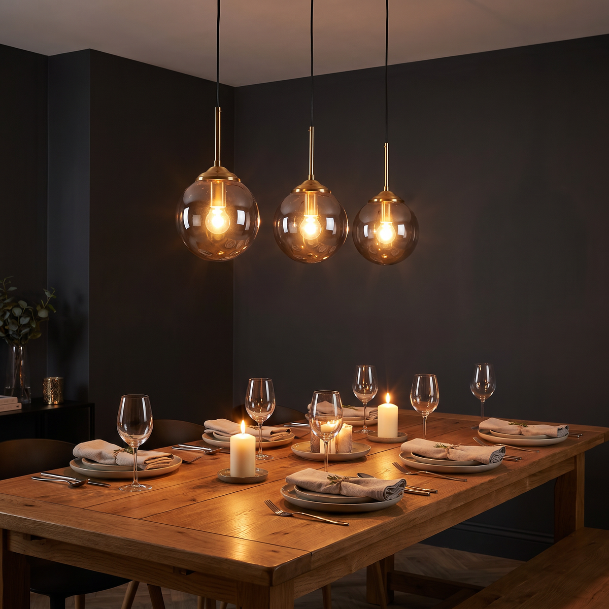 Orla pendant lit above a dining table in the evening