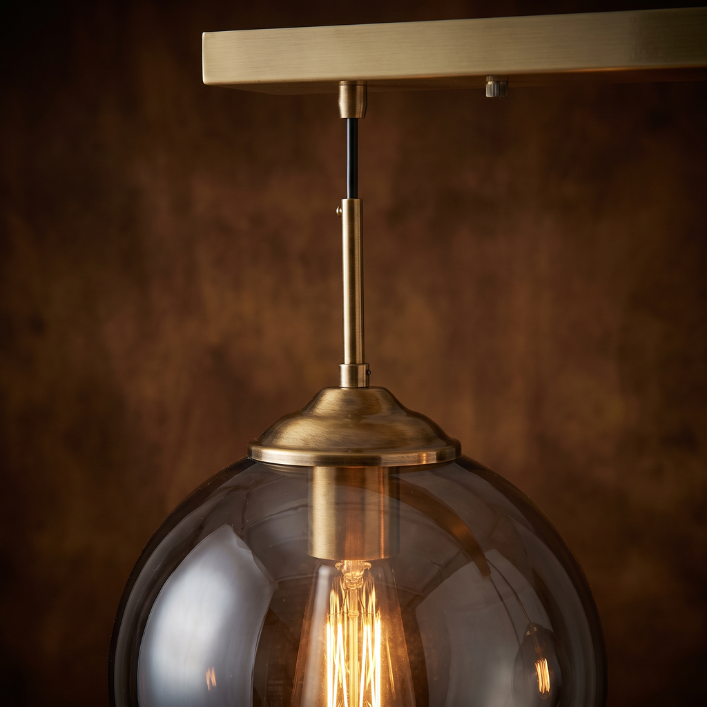 Close up of a smoked glass globe and brass holder