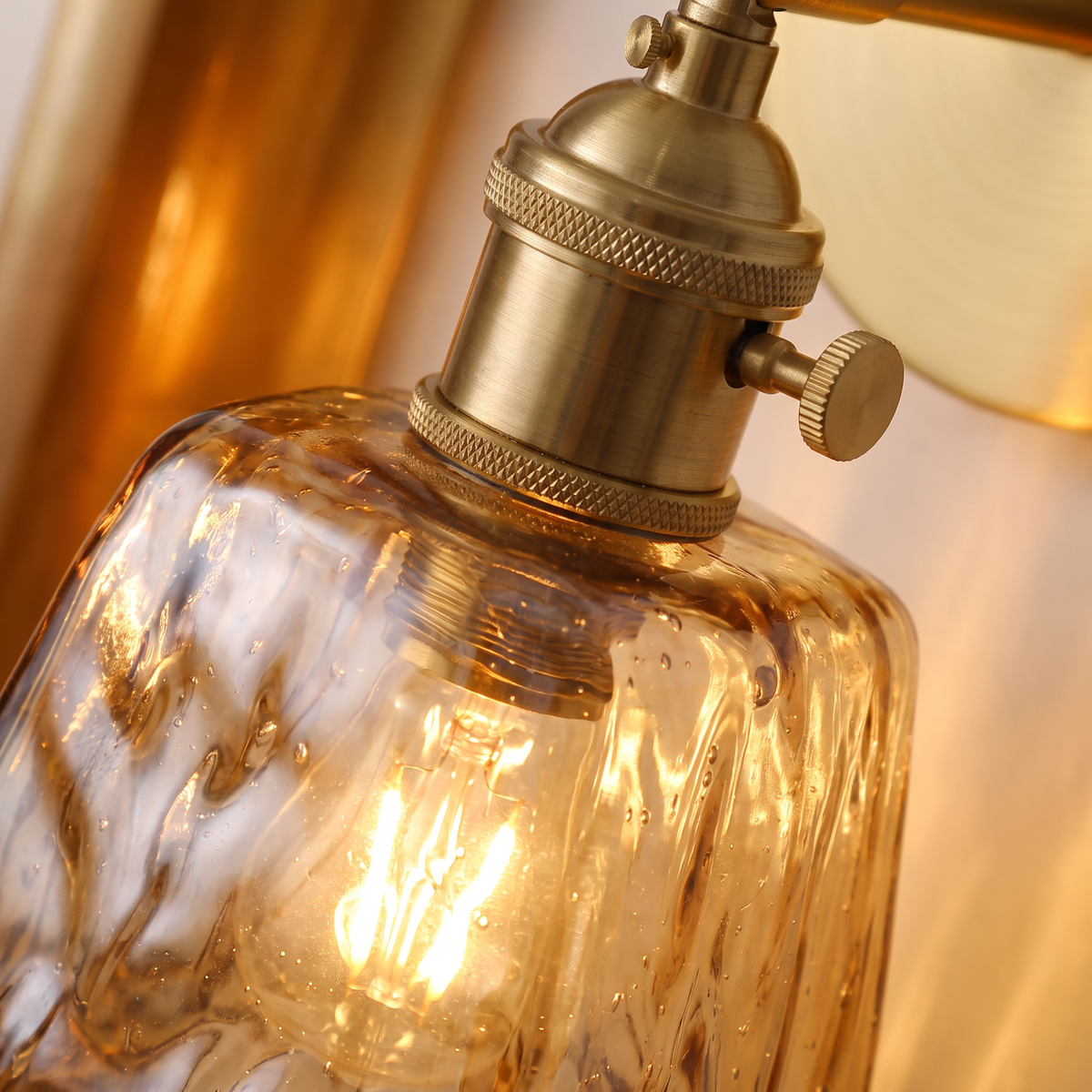 Close up of the rippled amber glass and brass holder
