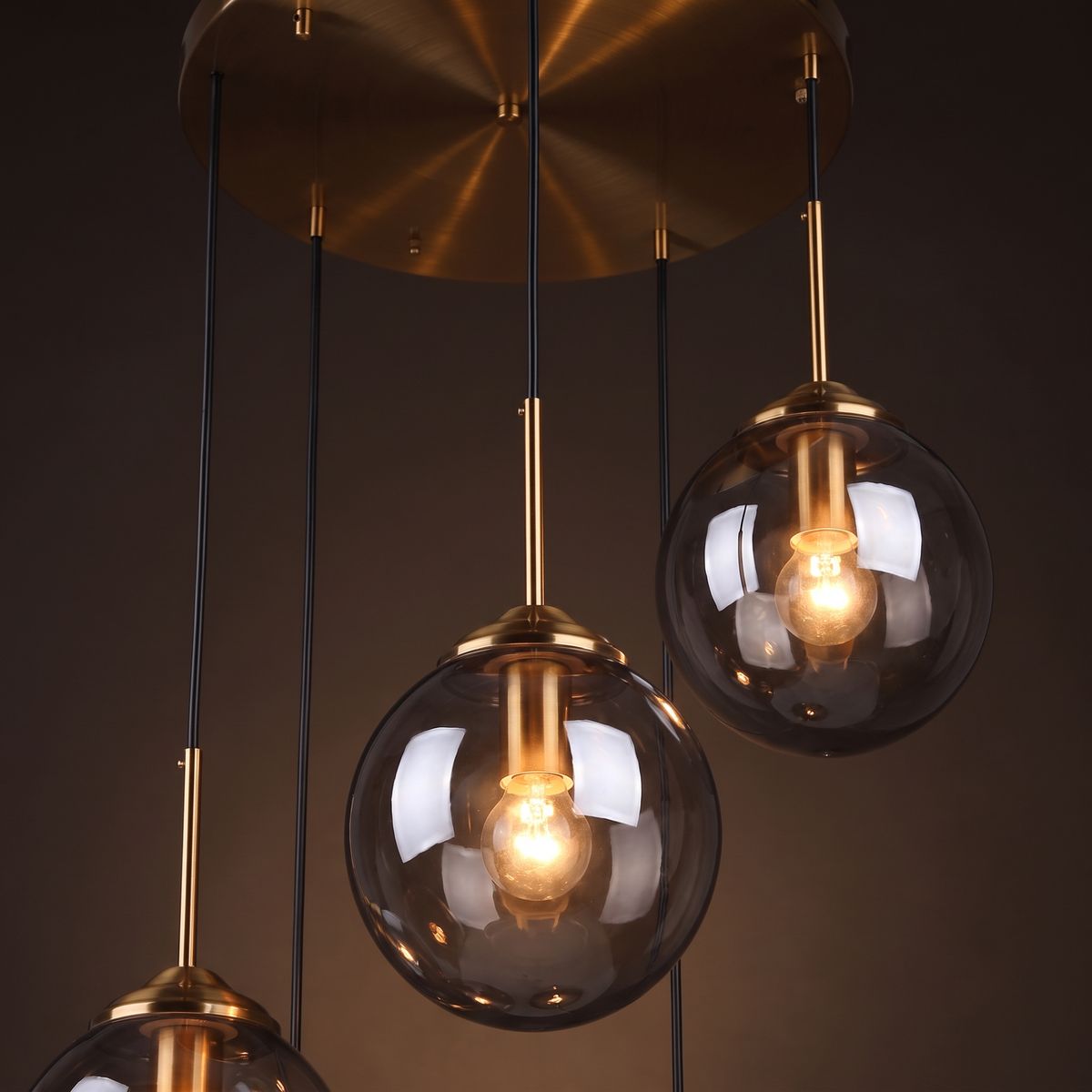 Close up of two smoked glass globes at different heights