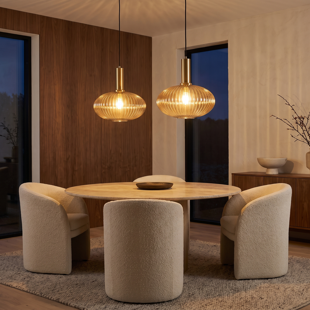 Two Linley pendants over a round travertine dining table