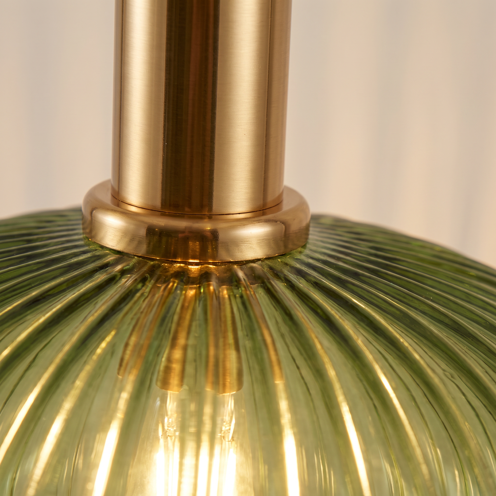 Close up of the ribbed green glass and brass cap