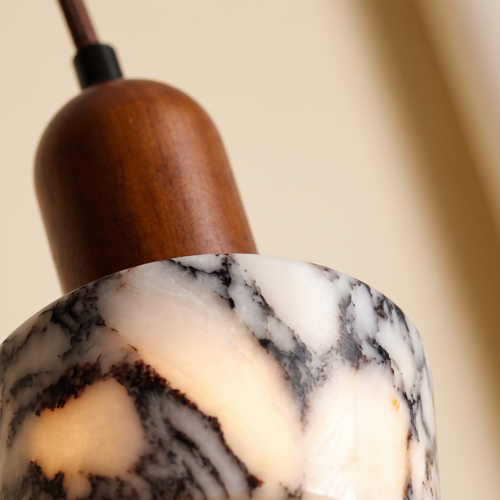 Close up of the veined marble and walnut cap