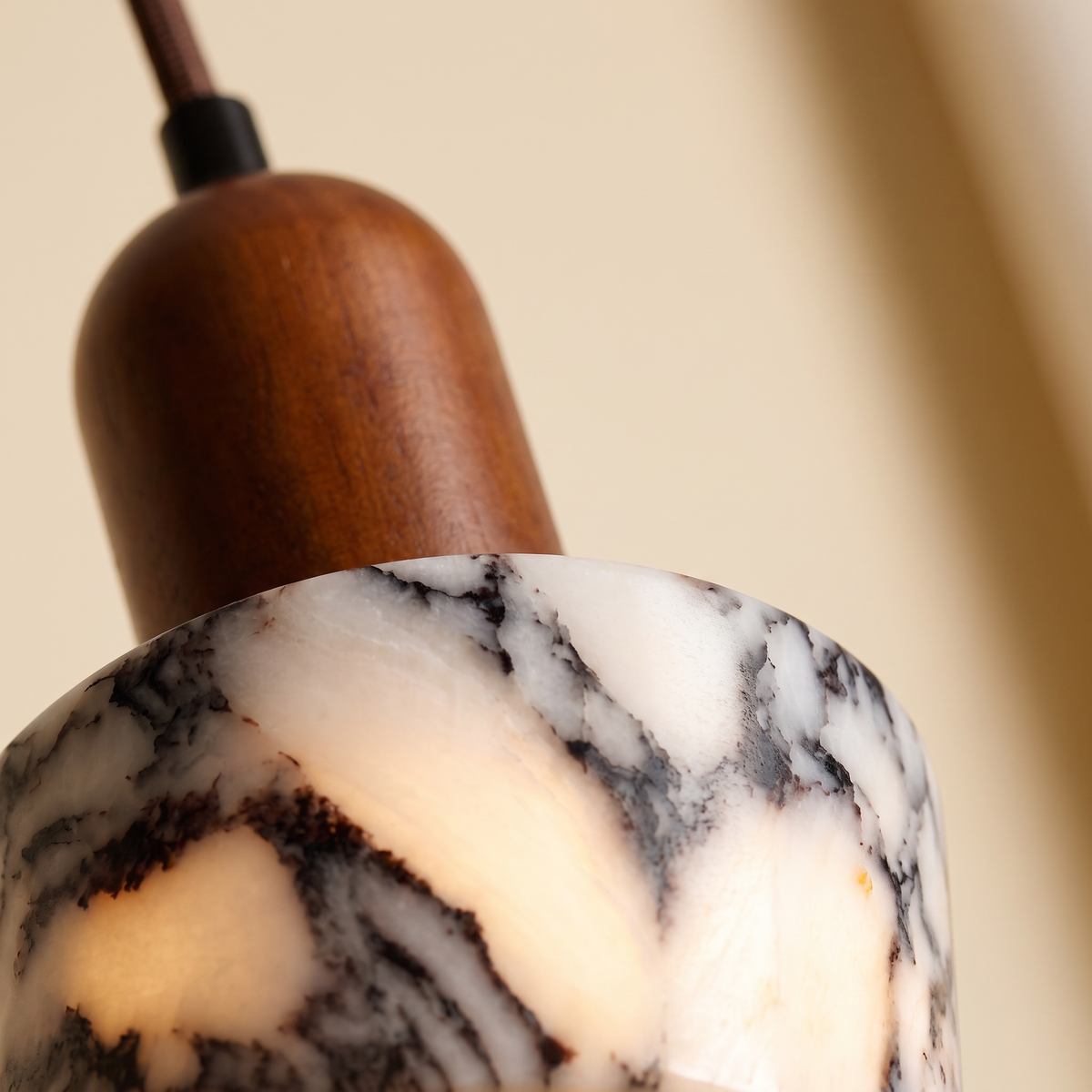 Close up of the veined marble and walnut cap