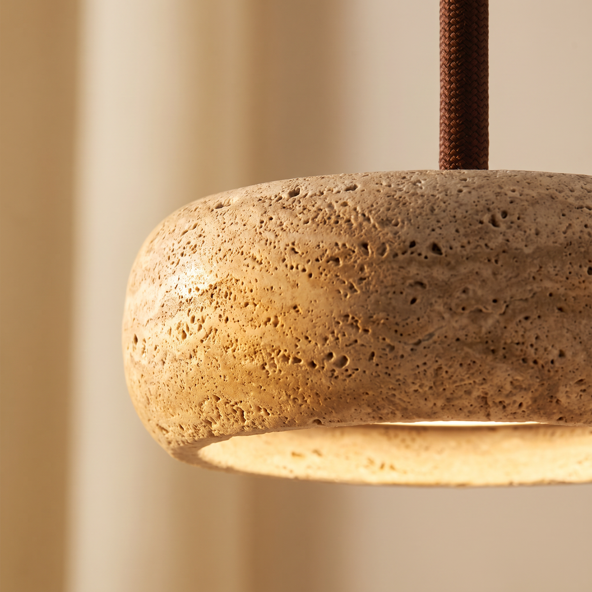 Close up of the natural travertine drum glowing from below